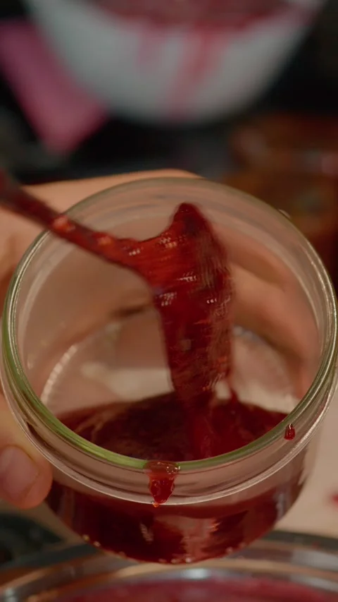 Vertical video Making homemade raspberry jam in a cozy kitchen Stock Footage 323362684