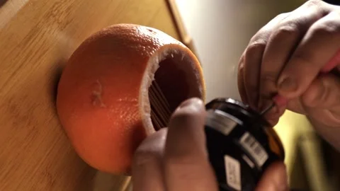 Vertical Video - Making Hookah on Grapefruit, Adding Tobacco Stock Footage 247137032