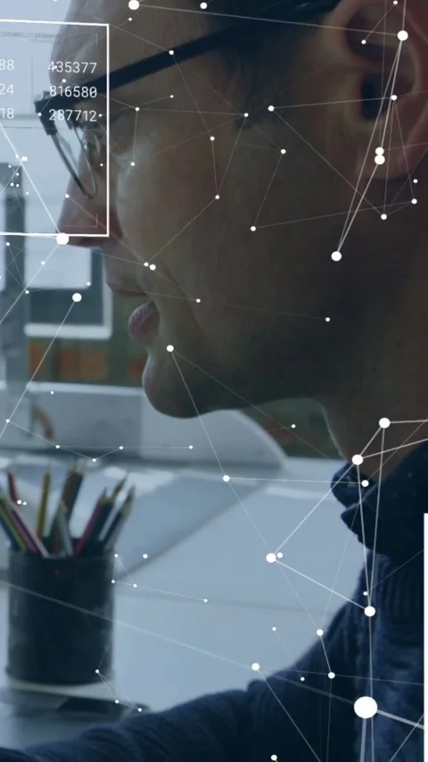 Vertical video: Male analyst leaning and speaking at desk, activating HUD nodes Stock Footage 334550539