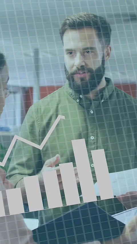 Vertical video: Male analyst showing sheet to peer, reviewing data charts on Stock Footage 335355191