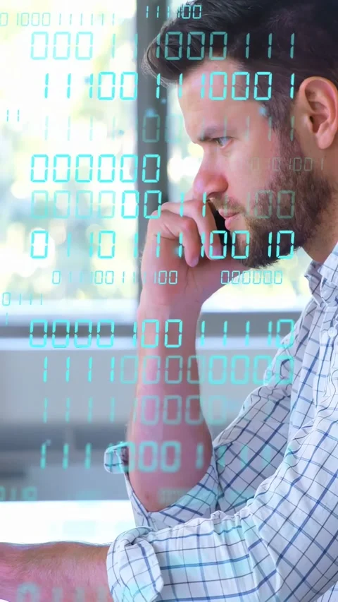 Vertical video: Male analyst taking incoming call, typing laptop, binary overlay Stock Footage 333513364