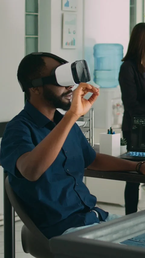 Vertical video: Male app developer using virtual reality glasses to code new Stock Footage 218575778