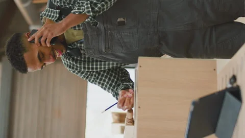 Vertical Video Of Male Apprentice Working As Carpenter In Furniture Workshop Stock-Footage 242438266