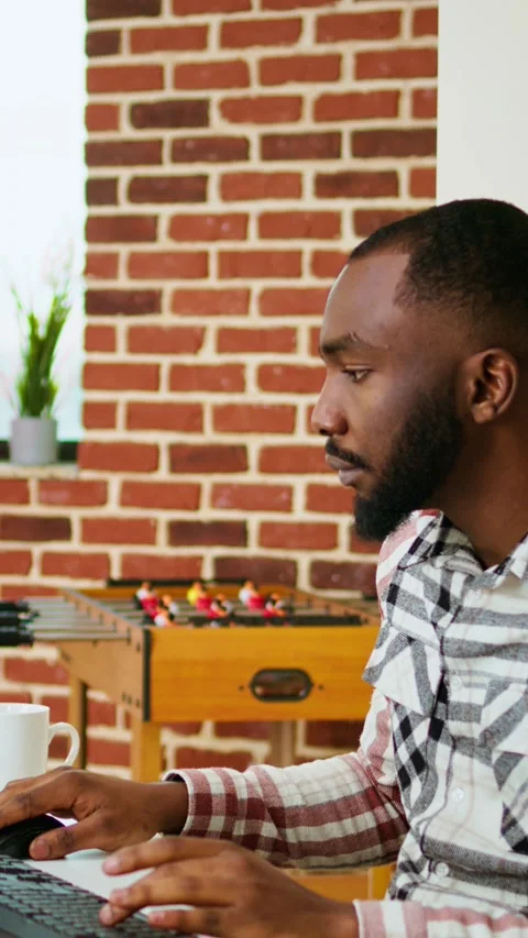 Vertical Video Male coder works from home typing code on a laptop in a modern Stock Footage 319475271