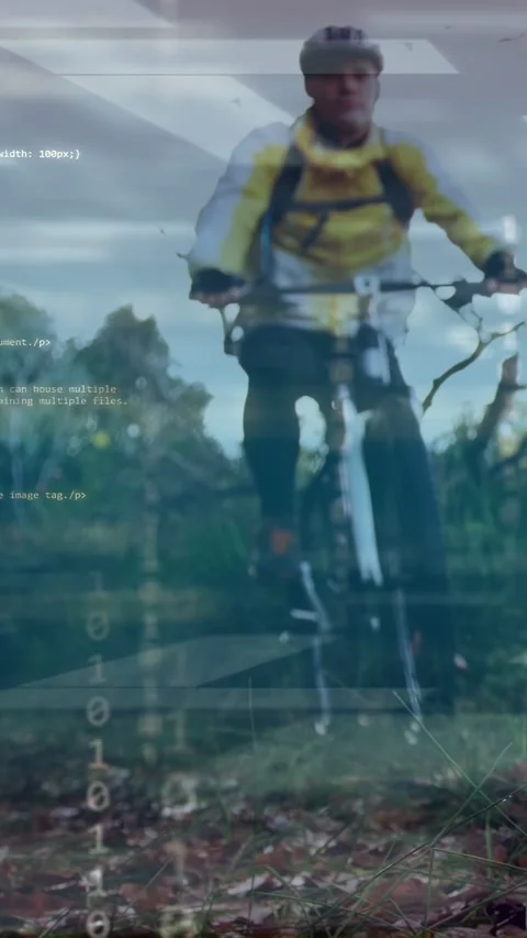 Vertical video: Male cyclist commuting and riding toward low camera, code Stock Footage 333745516