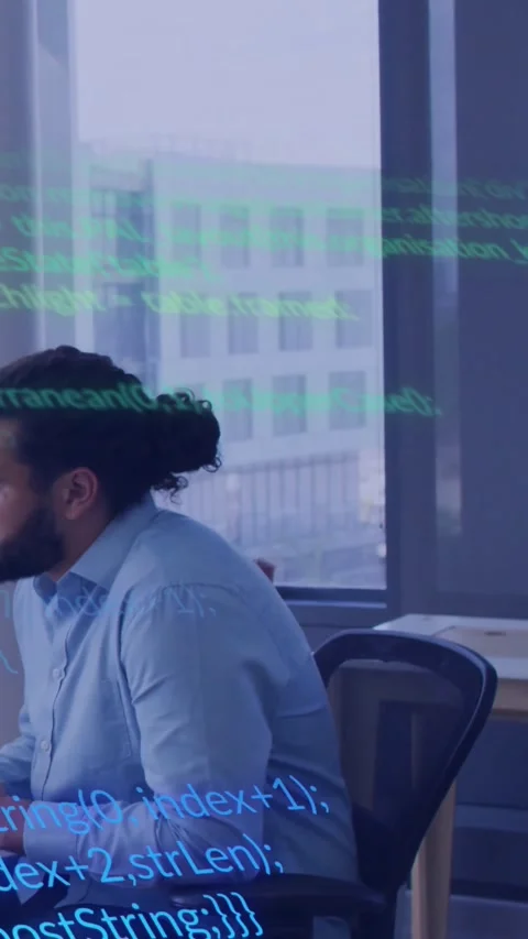 Vertical video: Male dev glancing left, shifting as code sweeping across face or Stock Footage 330260543