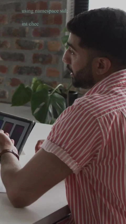 Vertical video: Male dev turning to colleague after gesture, reviewing tablet Stock Footage 329840854