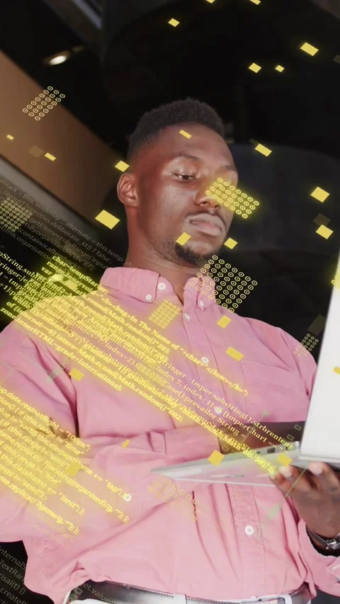 Vertical video: Male dev typing on laptop, initiating green code overlays around Stock Footage 334770819