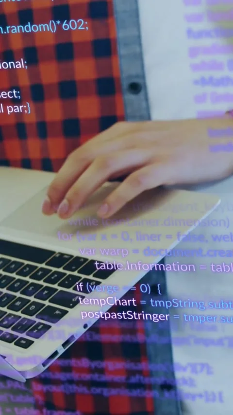 Vertical video: Male developer tapping laptop pad then picking tablet, code Stock Footage 333835941