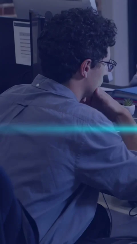 Vertical video: Male developer typing at desk, causing code glitch overlays Stock Footage 334771126