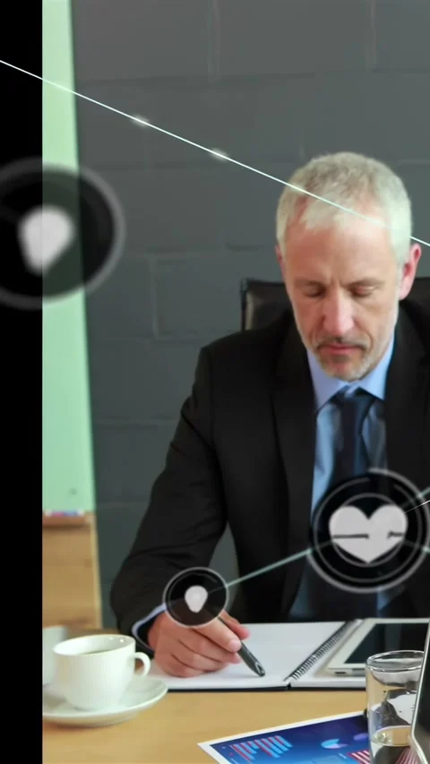 Vertical video: Male exec writing at table pen sparking animated biz icons Stock Footage 334396998