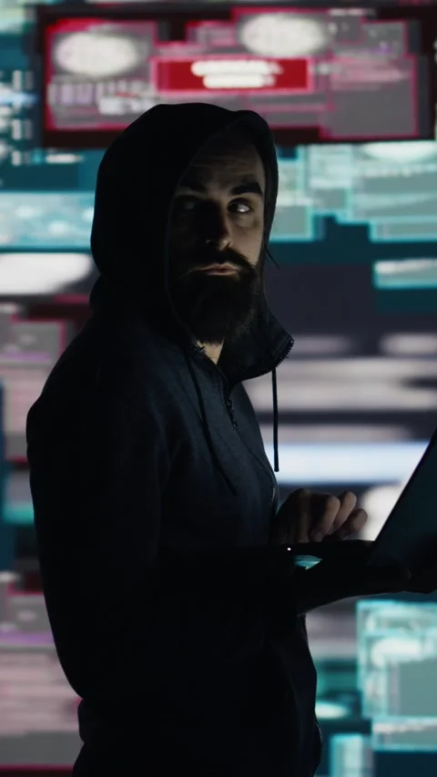 Vertical Video Male hacker operates in stealth mode breaching system access Stock Footage 310703988