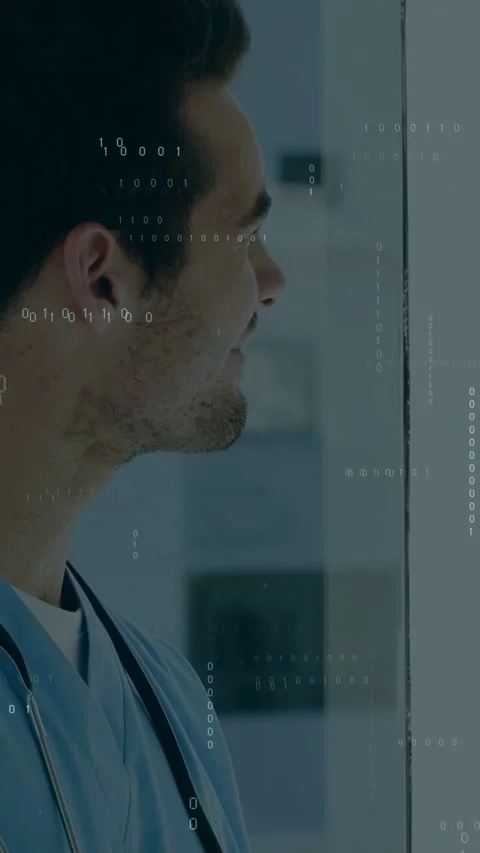 Vertical video: Male medic tapping tablet, showing binary code, pulling back Stock Footage 333513532