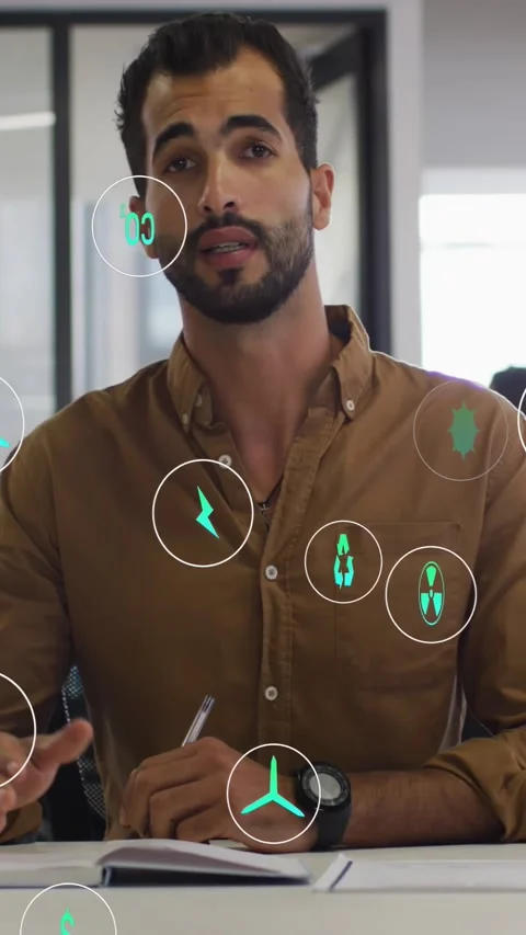 Vertical video: Male presenter gesturing at desk, generating green icons about Stock Footage 334544385