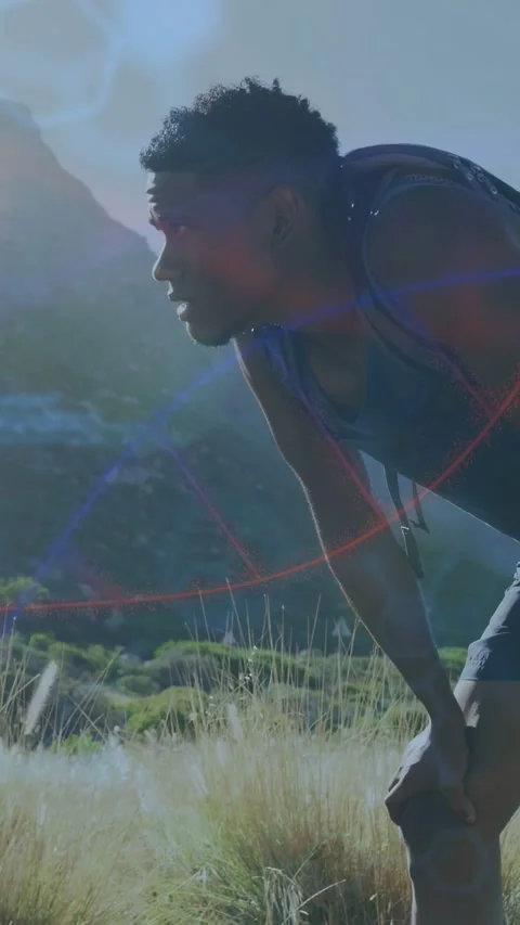 Vertical video: Male runner pausing on sunny hill, fitness tech overlays Stock Footage 333528209