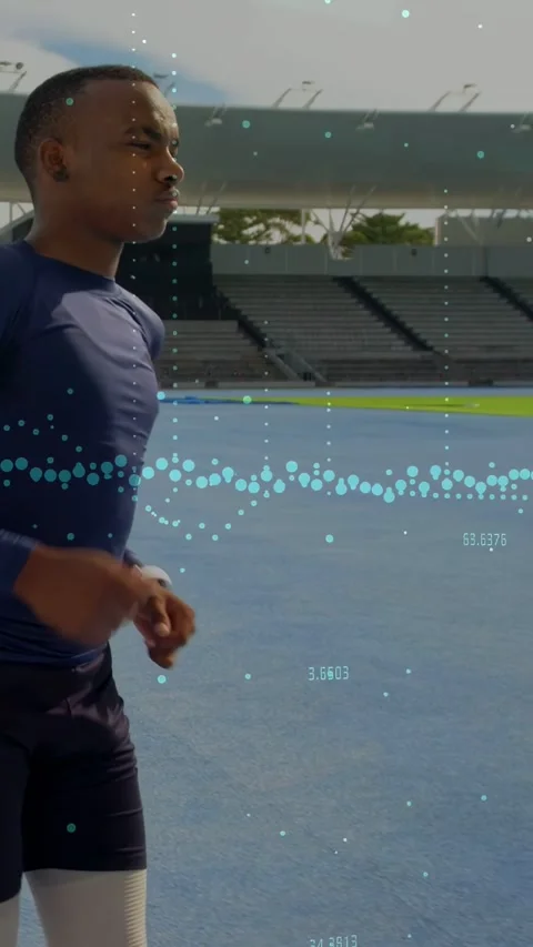 Vertical video: Male runner running on blue track while camera tracking and Stock Footage 335513900