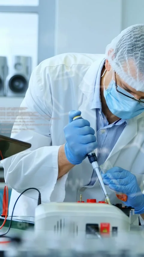 Vertical video: Male scientist aligning tip after tablet showing code guiding Stock Footage 335264083