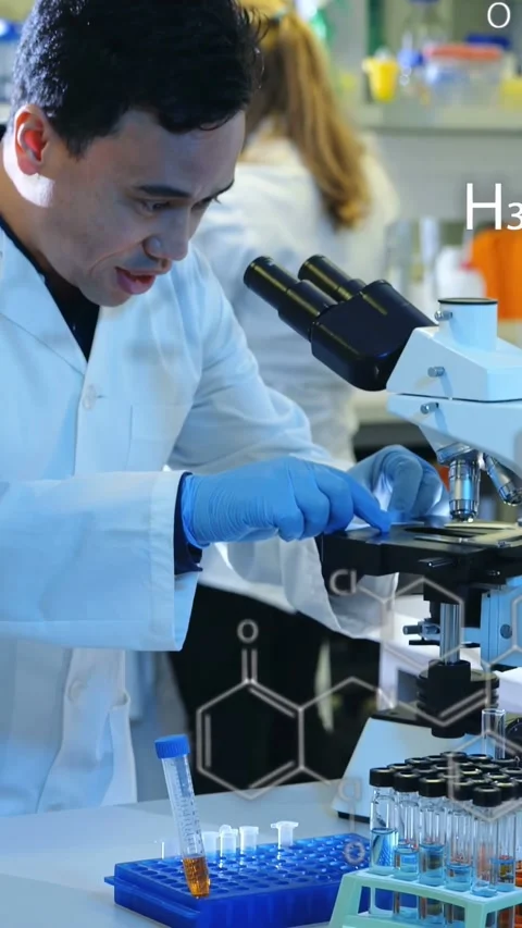 Vertical video: Male tech taking slide loading scope focusing for lab tests Stock Footage 335264219