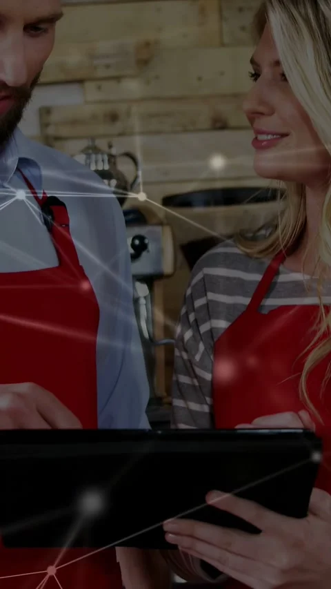 Vertical video: Male trainer tapping tablet teaching staff in cafe, network Stock Footage 333861814