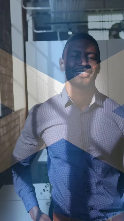 Vertical video: Man adjusting and smiling in office as frames playing blue X Stock Footage 333527884