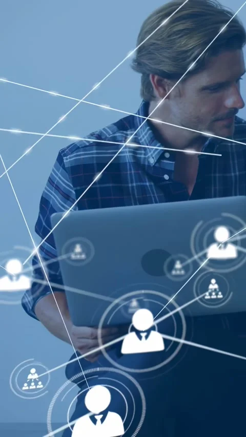 Vertical video: Man adjusting laptop and glancing right, starting tech network Stock Footage 334386986
