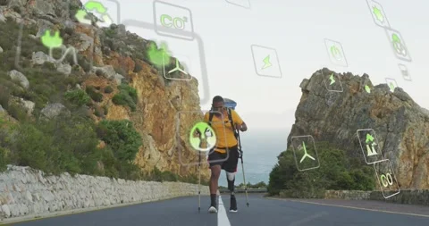 Vertical video: Man approaching camera on road adding eco icons over prosthetic Stock Footage 334185049