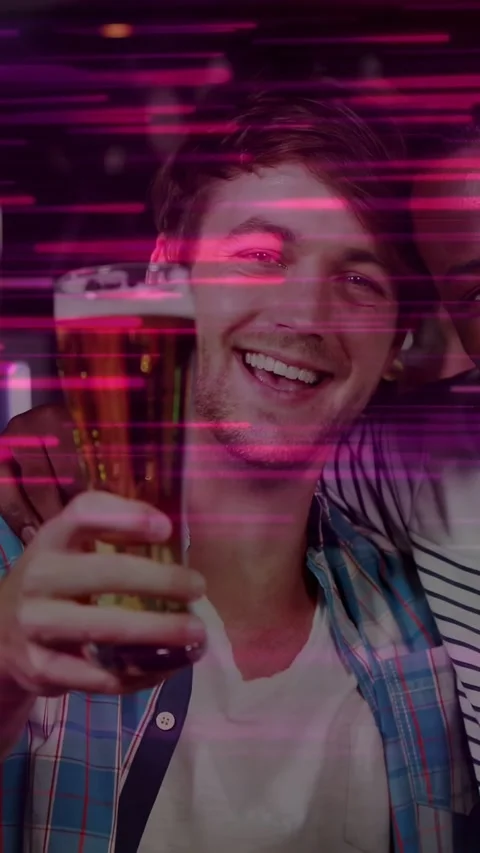 Vertical video: Man in blue plaid lifting pint to camera after cheers, pink Video stock 333109893