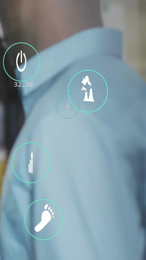 Vertical video: Man in blue shirt still, teal UI on shoulder, tech icons Stock Footage 334317332