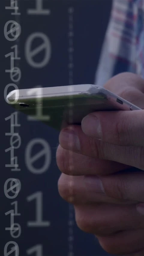 Vertical video: Man bringing phone, thumb swiping and overlaying binary morphing Stock Footage 335355153