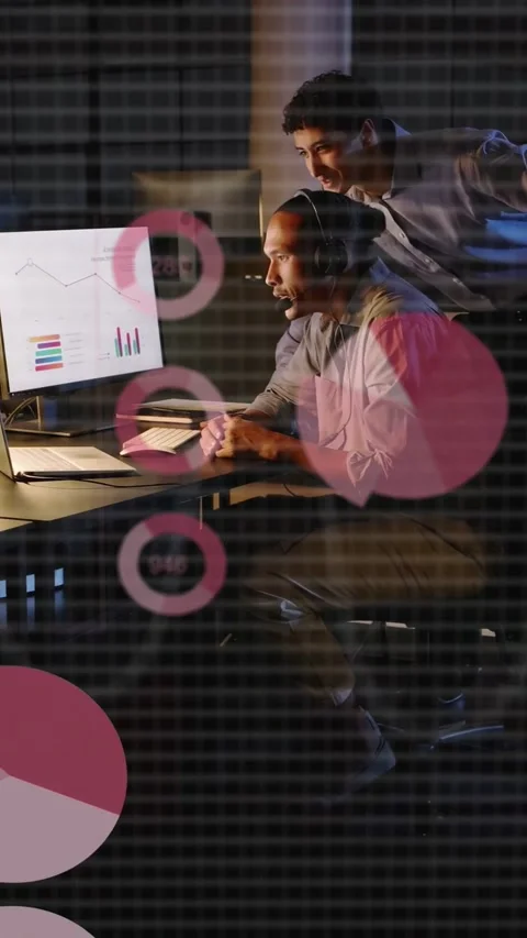 Vertical video: Man on call, peer leaning pointing adding data charts and CSV on Stock Footage 335802577