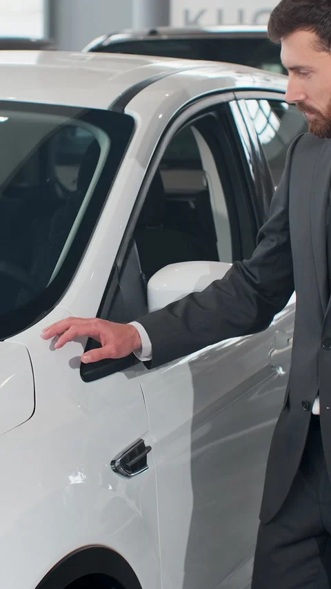 Vertical Video Man is choosing new automobile walking around luxury car Stock Footage 337882274