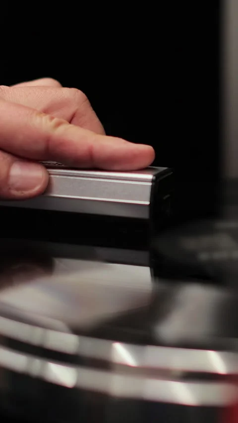 Vertical video Man cleaning retro vinyl with special brush - turntable Stock Footage 338084473