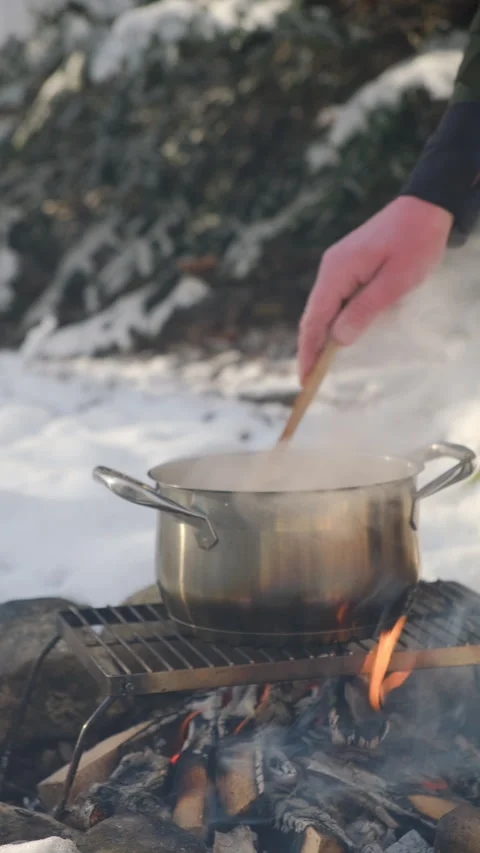 Vertical video of man cooking mulled wine with oranges, apples at winter time Stock Footage 300940327