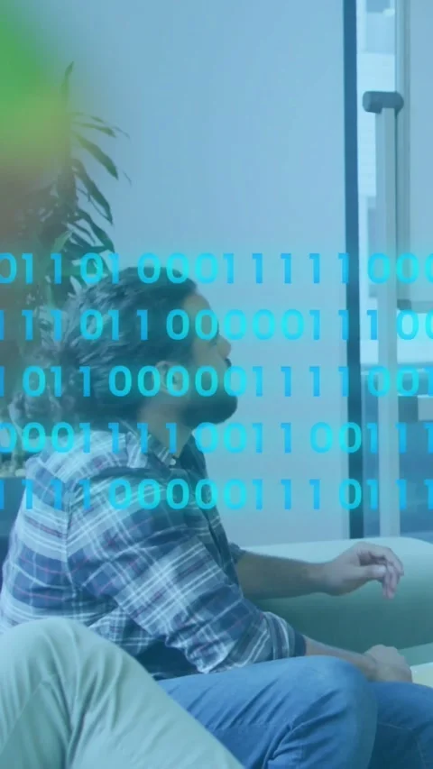 Vertical video: Man on couch noticing binary stream on glass, tapping UI and Vídeos de archivo 331128540