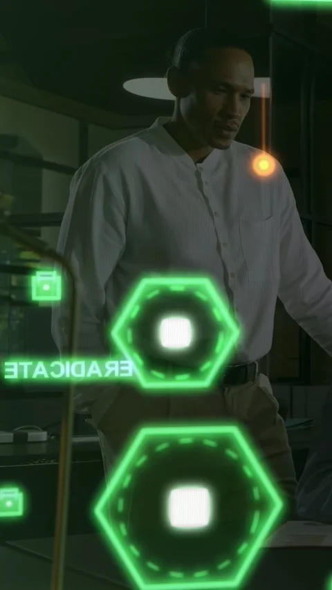Vertical video: Man at desk checking data on tech UI after orange orb triggers Stock Footage 333692258