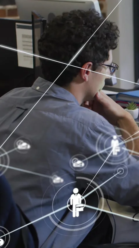 Vertical video: Man at desk clicking mouse, overlaying tech network around him Stock Footage 330769423