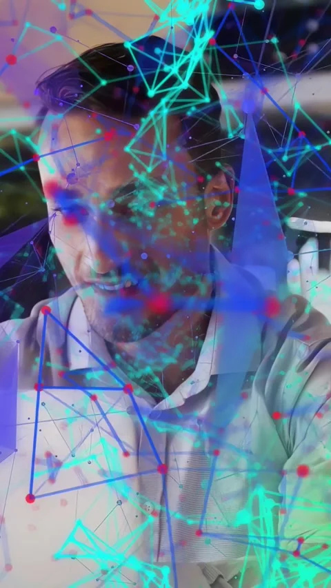 Vertical video: Man at desk looking at laptop, causing cyan node overlay, Stock Footage 337540594