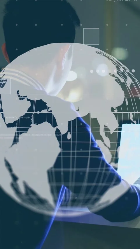Vertical video: Man at desk reaching monitor as appearing rotating globe guiding Stock Footage 335355527