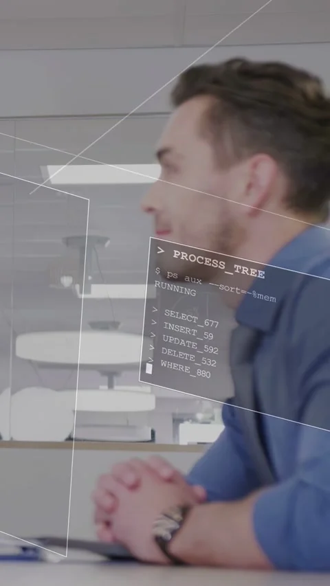 Vertical video: Man at desk watching as system loading PROCESS_TREE UI showing Stock Footage 333541803