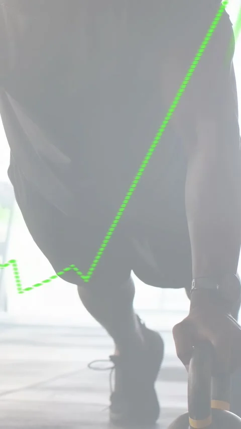 Vertical video: Man doing KB pushups in gym, starting reps as green graph Stock Footage 332644937