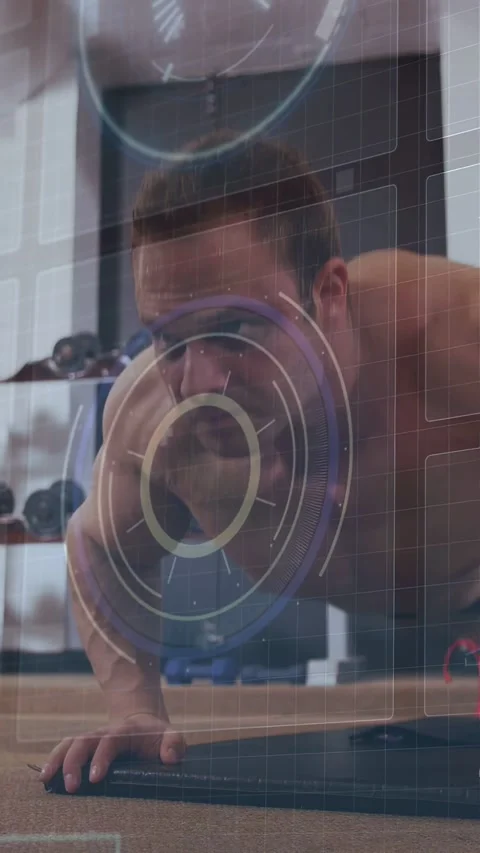 Vertical video: Man doing pushups on mat in gym, lowering for strength, HUD Stock Footage 332595283