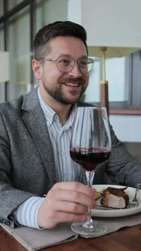 Vertical Video Man drinking wine with his wife at dinner in a restaurant. P.. Stock Photos