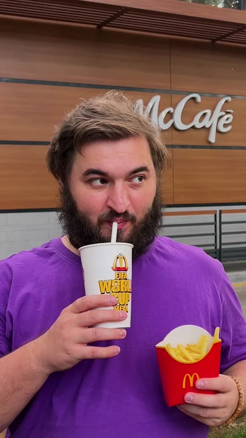 Vertical video. Man drinks Pepsi lemonade near cafe Stock Footage 338312778