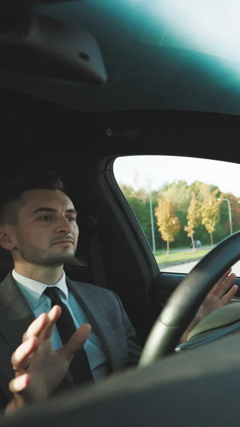 Vertical Video of Man driving in innovative automated car using self-parking Stock Footage 302651725