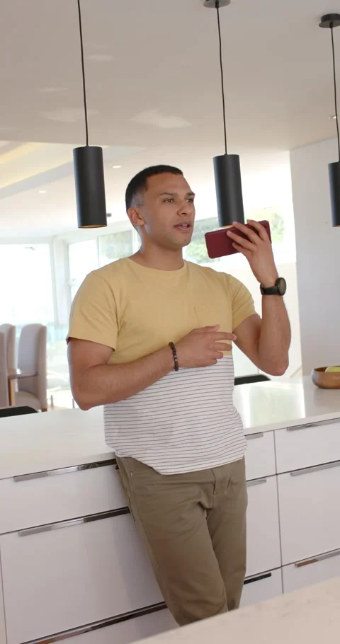 Vertical video: Man entering and leaning while scrolling smartphone and speaking Stock Footage 345395690