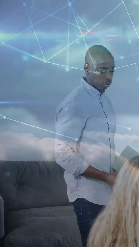 Vertical video: Man entering frame reading folder in lounge, showing tech Stock Footage 329961908