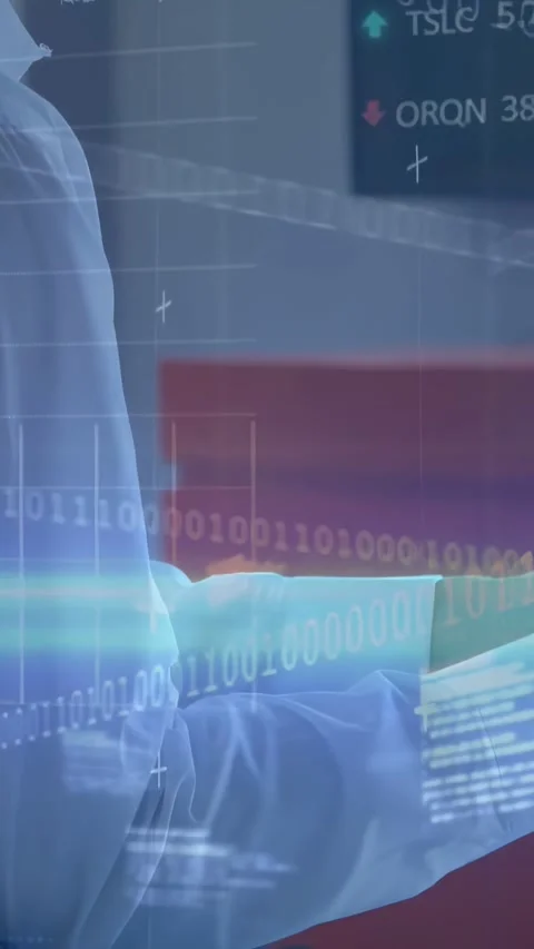 Vertical video: Man extending arm and typing at desk while HUD stock charts Stock Footage 332335413
