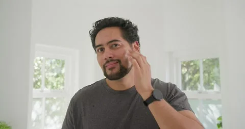 Vertical video: Man feeling cheek reaching pipette putting serum rubbing face Stock Footage 337625330
