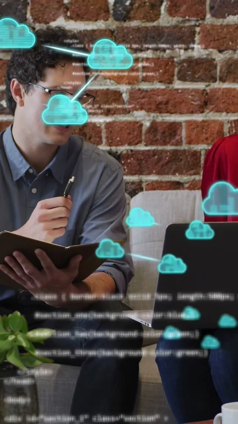 Vertical video: Man gesturing and woman on laptop causing cloud icons and code Stock Footage 332775890