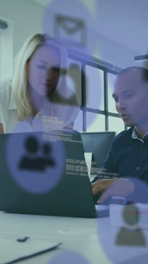 Vertical video: Man gesturing at laptop, woman leaning, purple icons drifting, Stock Footage 333006345